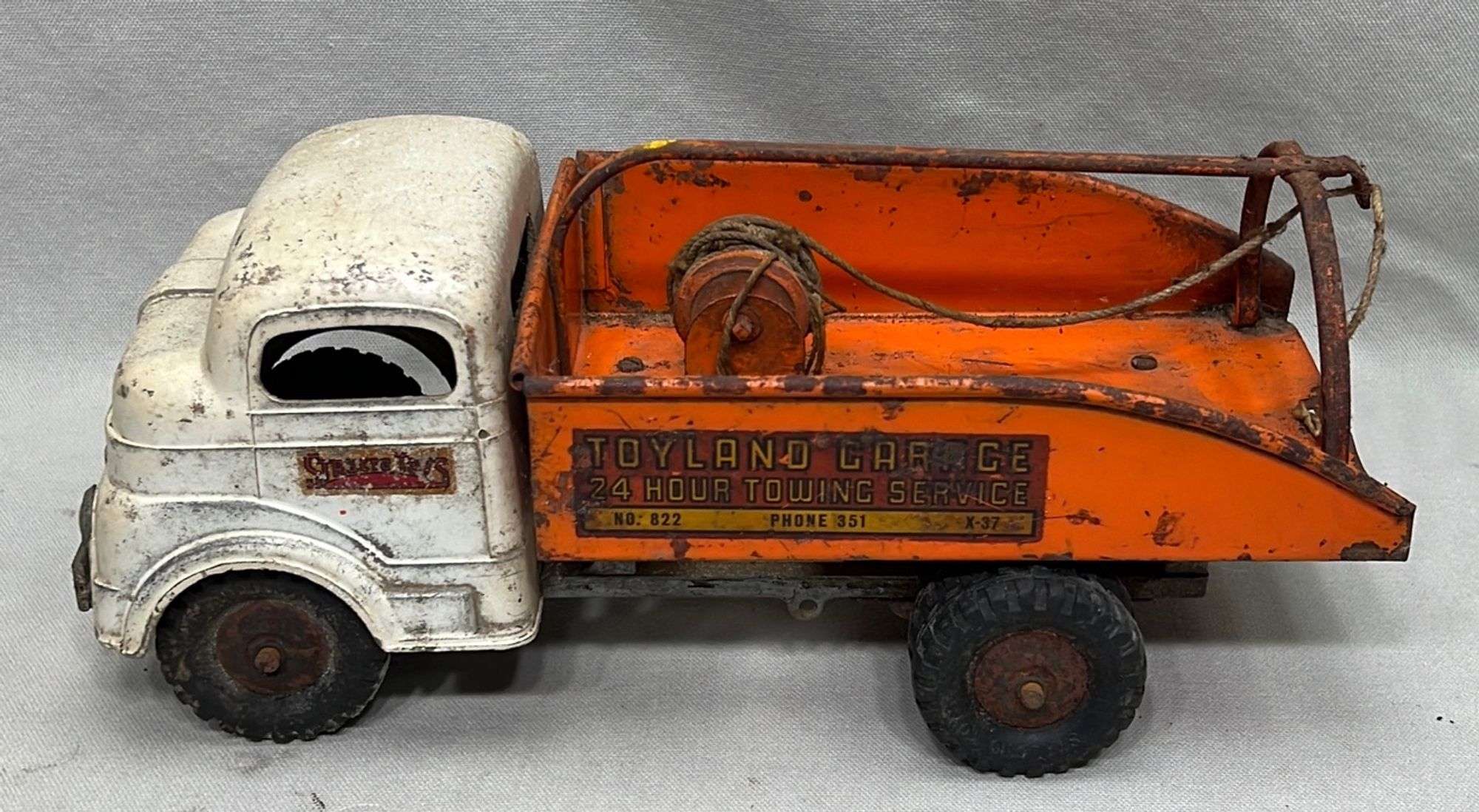 Appraisal: Structo Toyland Garage pressed steel tow truck toymid th century