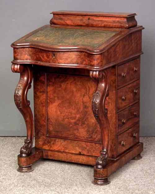 Appraisal: A Victorian figured walnut Davenport fitted four false and four