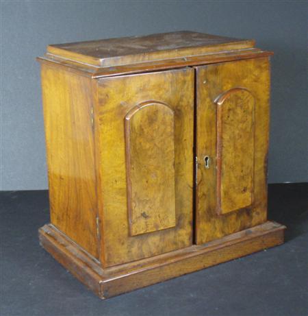 Appraisal: A th century walnut miniature collector's cabinet the moulded cornice