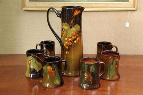 Appraisal: ART POTTERY PITCHER AND MUGS All the pieces have cherry