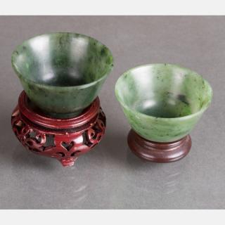 Appraisal: Two Chinese Carved Spinach Jade Cups on Carved Hardwood Stands