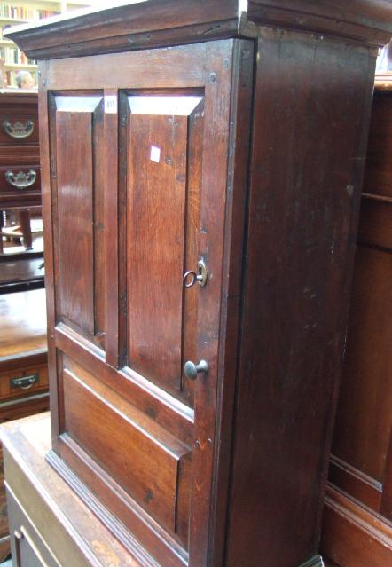 Appraisal: An th century oak hanging cupboard the triple panel door