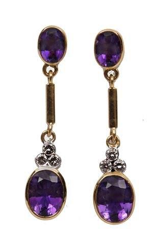 Appraisal: A PAIR OF AMETHYST AND DIAMOND EARDROPS oval faceted amethyst