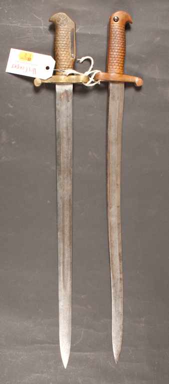 Appraisal: Two bayonets one unmarked with feathered pattern brass grip other