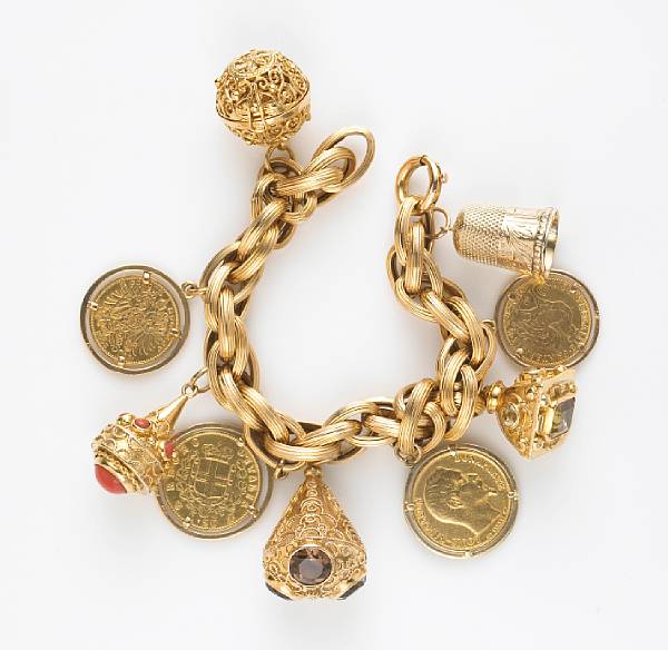 Appraisal: An k and k gold charm bracelet suspending eight gem-set