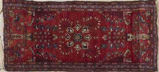 Appraisal: A Sarouk Wool Mat having a stylized foliate center medallion