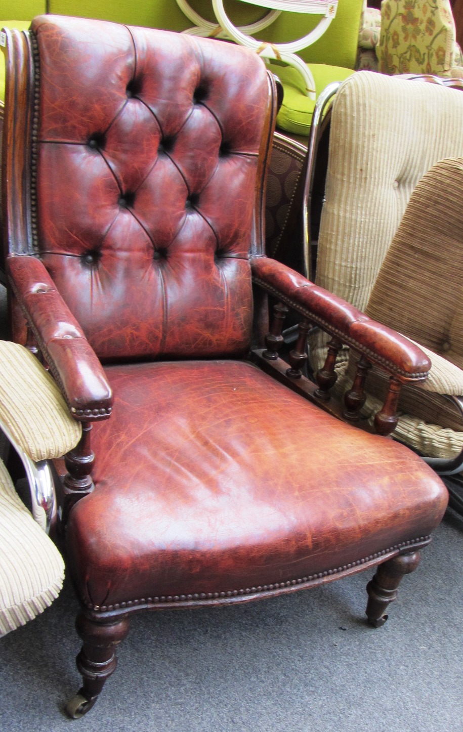 Appraisal: A Victorian oak and rouge leather upholstered armchair with bow