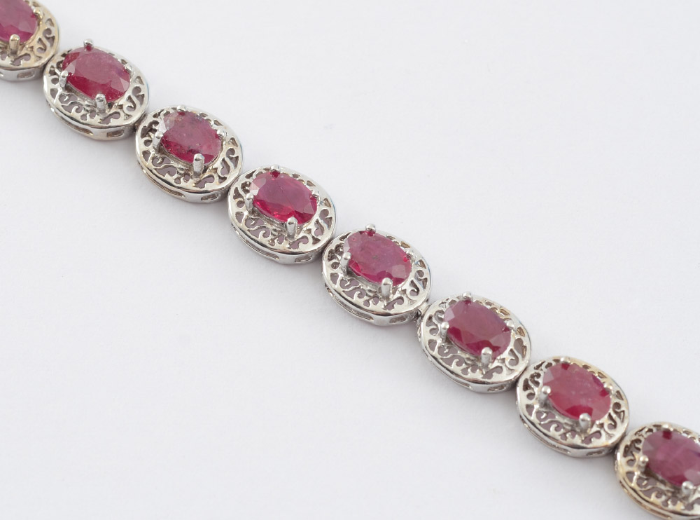 Appraisal: K RUBY LINE BRACELET Filigree links with oval mixed cut