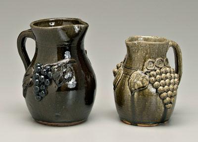 Appraisal: Two Meaders pottery pitchers both with applied grapes and leaves