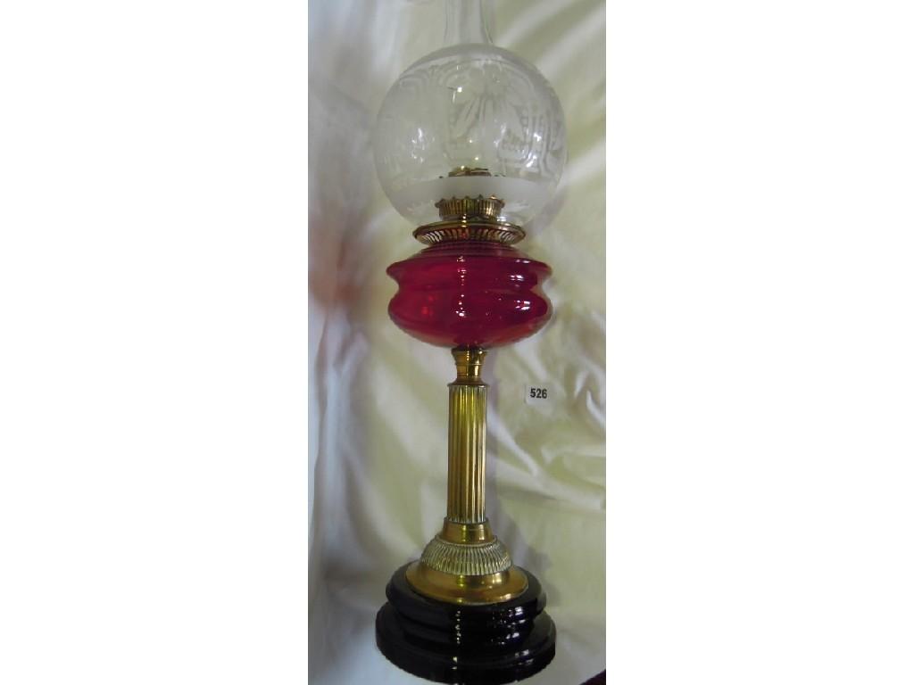 Appraisal: A Victorian oil lamp with spherical glass shade red glass