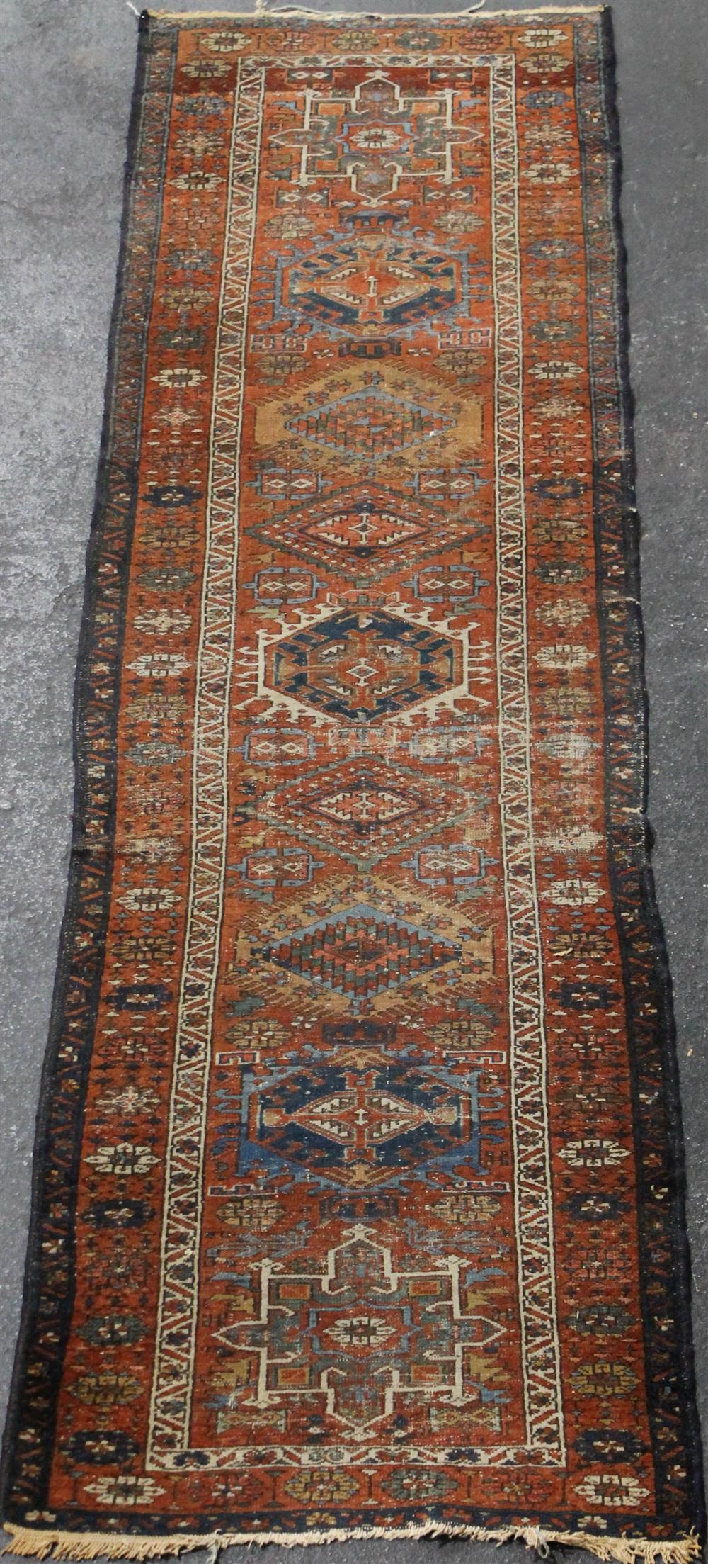 Appraisal: LARGE HAMADAN WOOL RUNNER having nine medallions on a rust