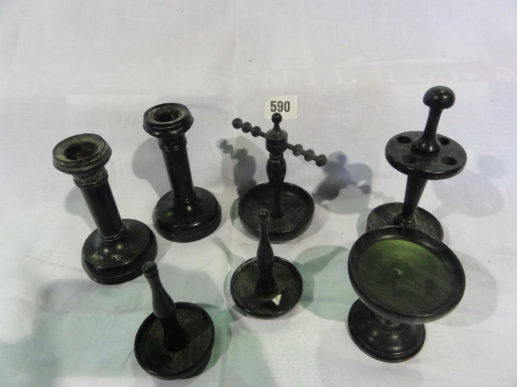 Appraisal: A collection of ebony pipe stands candlesticks tobacco jars cotton