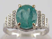 Appraisal: A white metal tests carat gold emerald and diamond ring