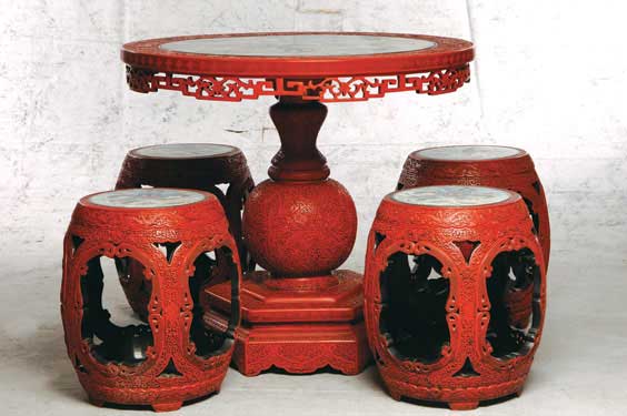 Appraisal: CHINESE LACQUER TABLE AND STOOLS Chinese carved cinnabar lacquer table