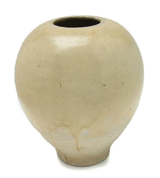 Appraisal: A straw glazed ceramic ovoid jar cut down Tang Period