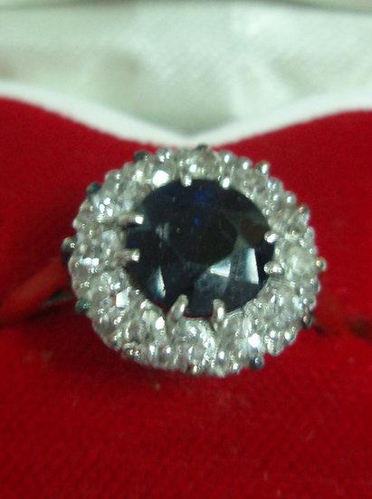 Appraisal: A sapphire and diamond cluster ring the central claw set