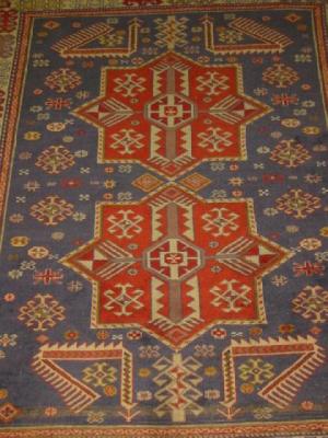 Appraisal: A CAUCASIAN RUG the navy blue floral field with two