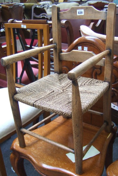 Appraisal: A beech and ash child's open armchair with hessian seat