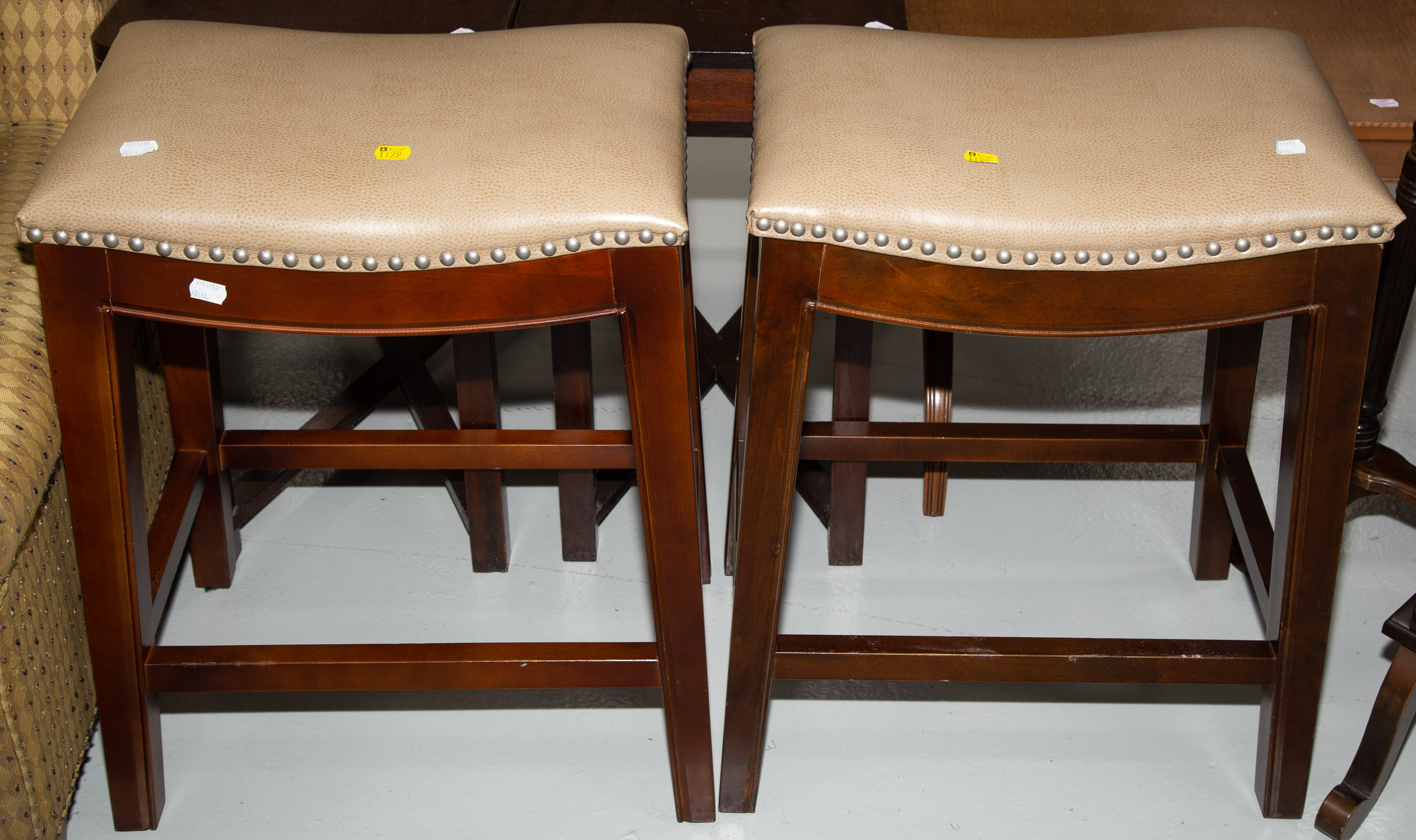 Appraisal: A PAIR OF CONTEMPORARY STOOLS With dark wooden frames and