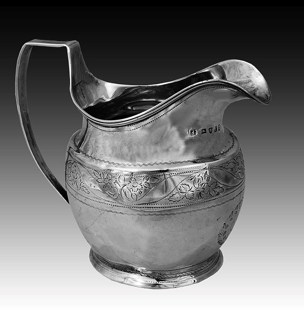 Appraisal: A GEORGE III SILVER MILK JUG oval shaped with engraved