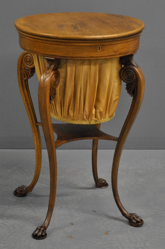 Appraisal: - Classical style rosewood sewing stand with animal paw feet