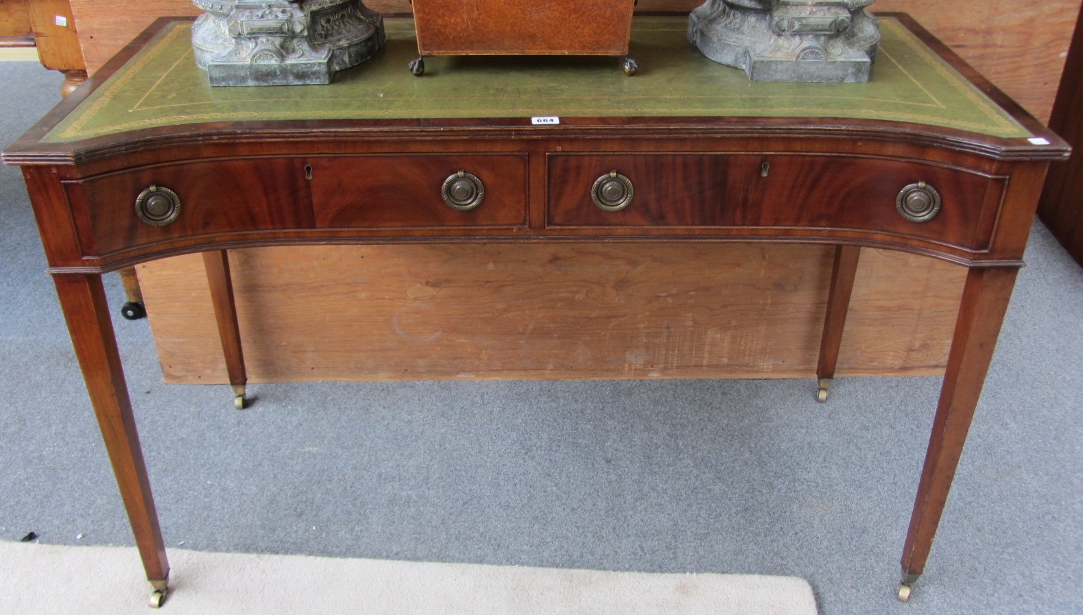 Appraisal: A early th century mahogany concave front two drawer writing