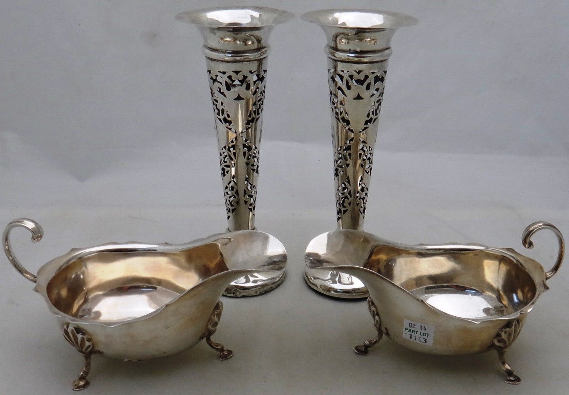 Appraisal: A pair of silver sauceboats with shaped rims and scrolling