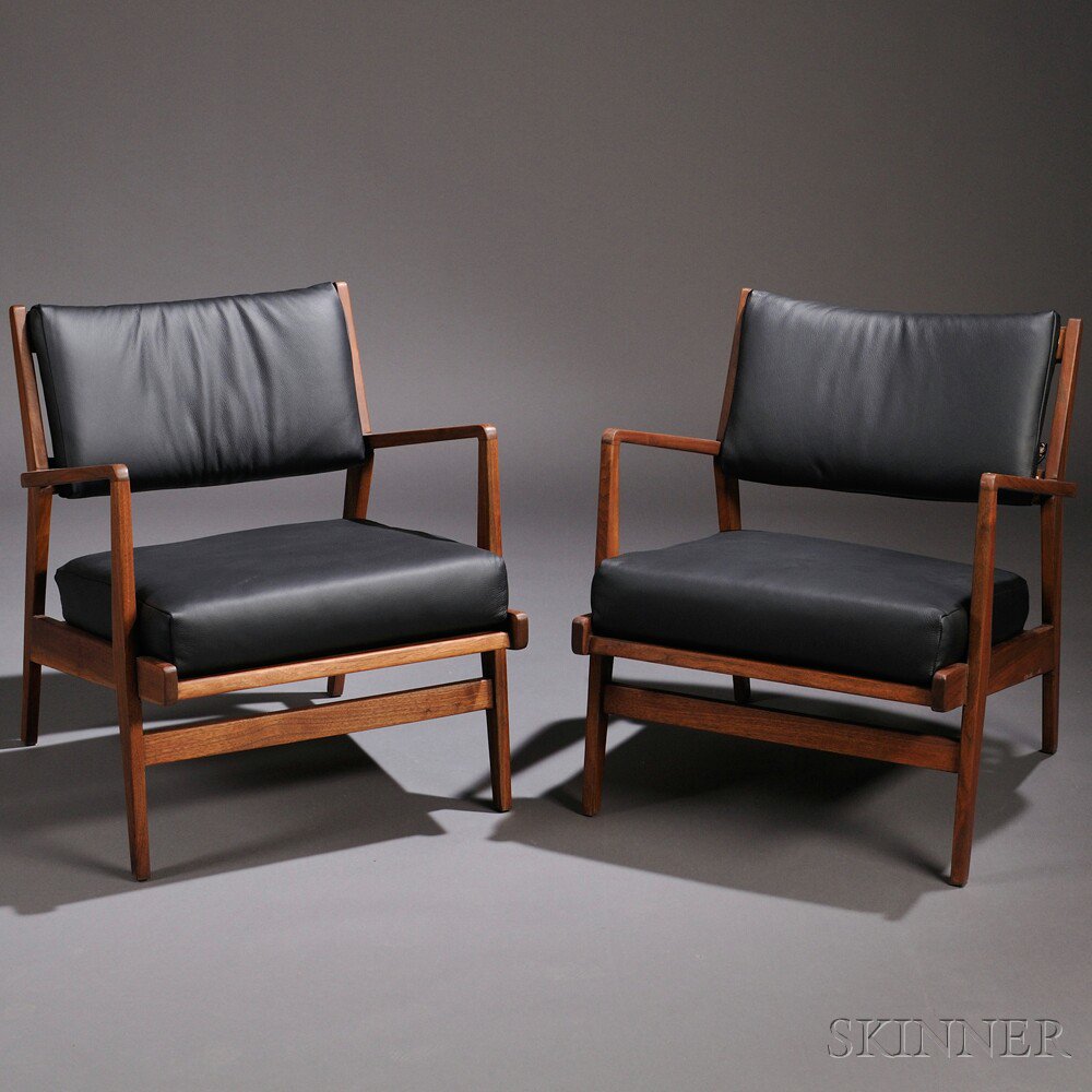 Appraisal: Two Jens Risom Lounge Chairs Walnut and leather Mid- th