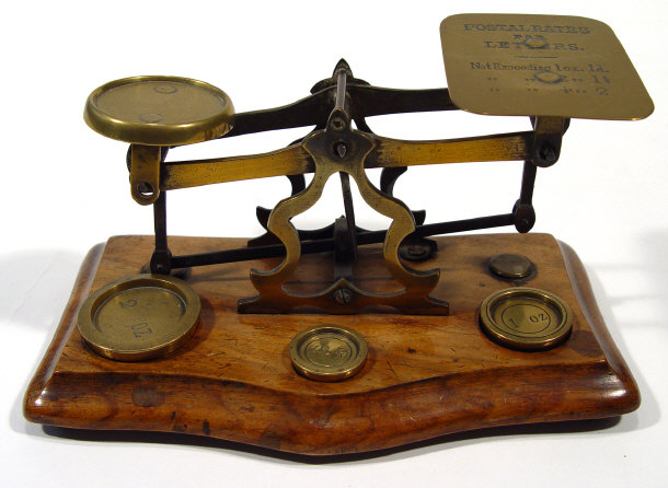 Appraisal: Set of brass postal scales with weights on a walnut