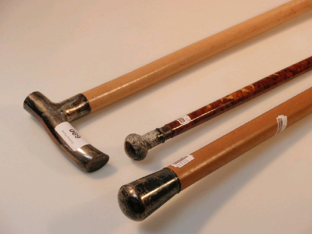 Appraisal: Mallaca dandy cane and walking stick with white metal mounts