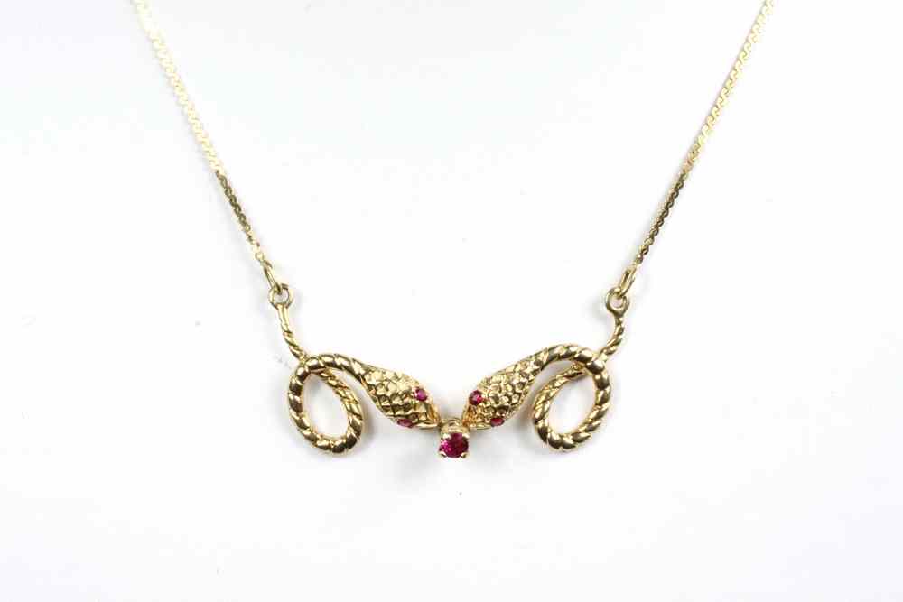 Appraisal: PENDANT - K yellow gold and ruby serpent pendant designed