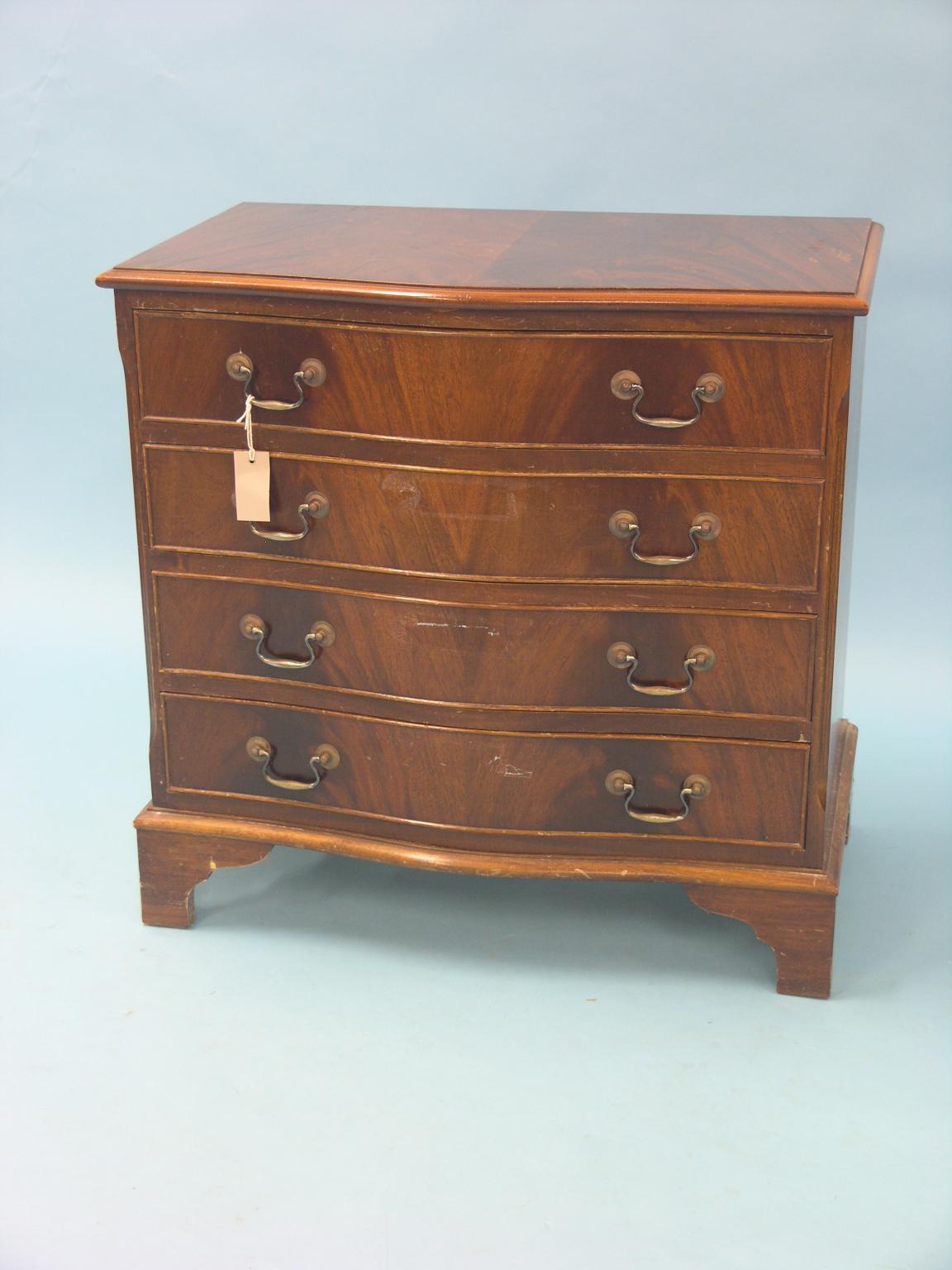 Appraisal: A reproduction mahogany serpentine chest flame-veneered with four long drawers