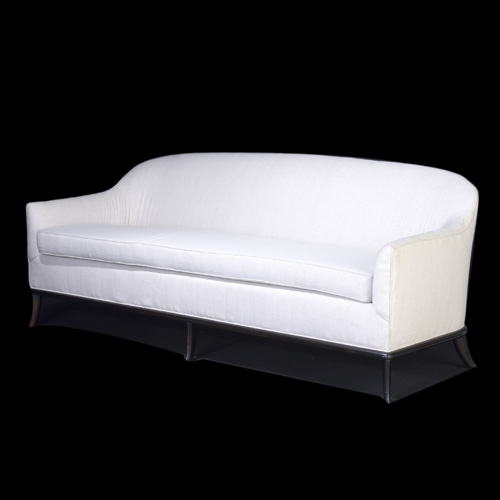 Appraisal: T H ROBSJOHN-GIBBINGS Sofa upholstered in off-white fabric on ebonized