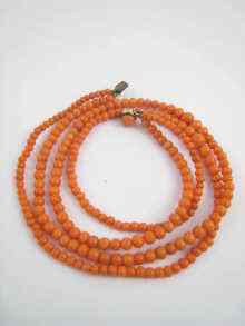 Appraisal: A graduated two row coral bead necklace the coral graduated