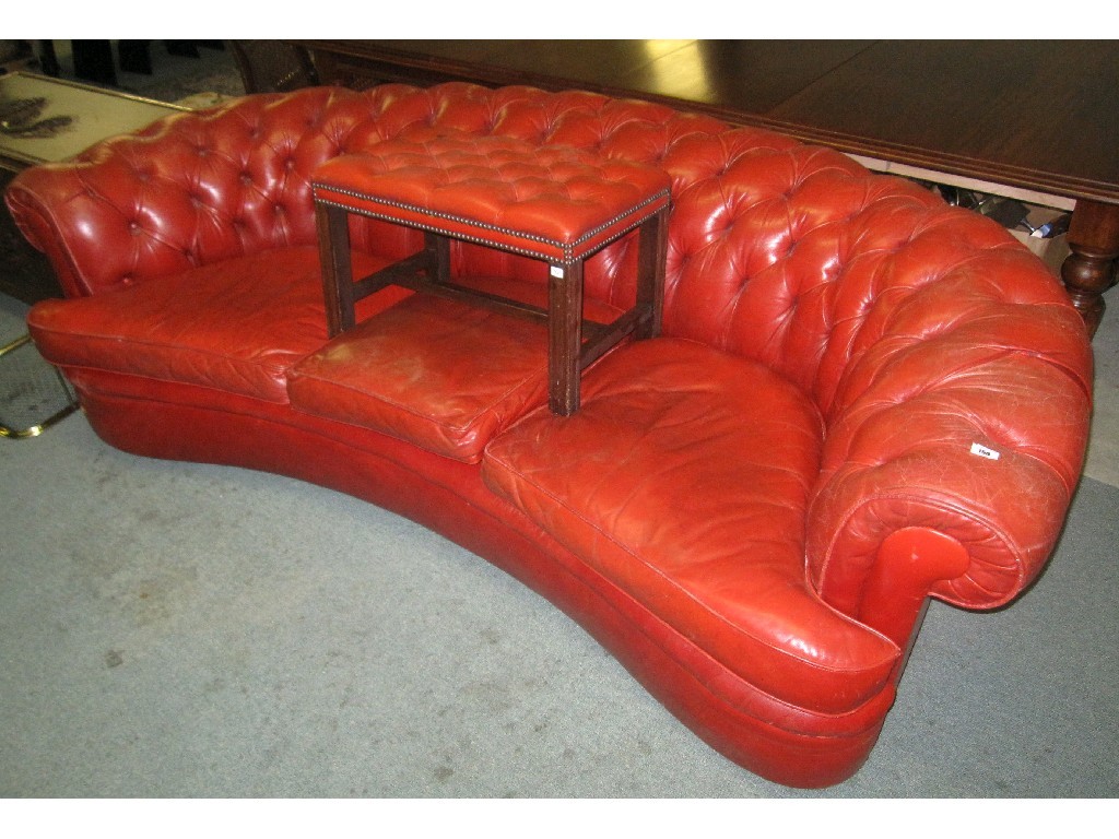 Appraisal: Red leather upholstered button back curved settee with footstool