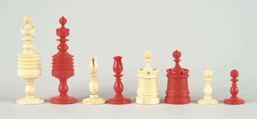 Appraisal: CARVED AND PAINTED IVORY CHESS SET Red stained pieces and