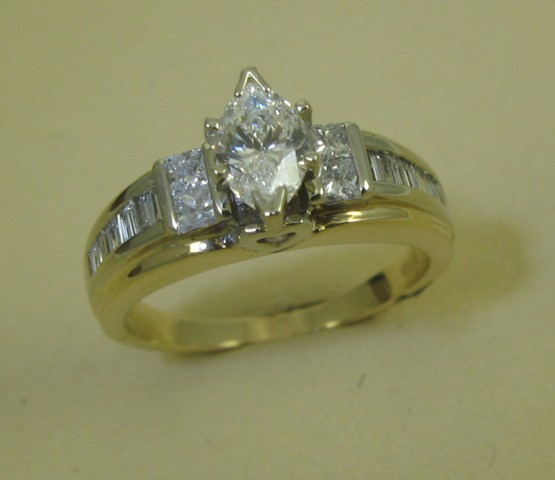 Appraisal: DIAMOND AND FOURTEEN KARAT GOLD RING featuring a centered marquise-cut