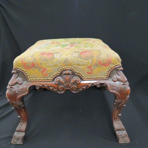 Appraisal: Large Carved Period Footstool Irish style design needlepoint top tall