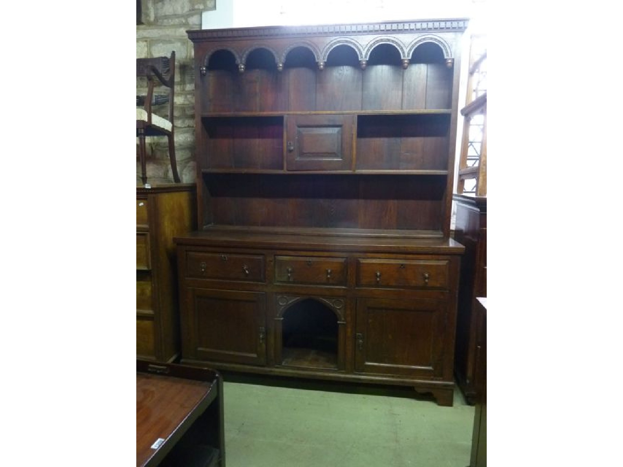 Appraisal: An oak dresser the base fitted with three frieze drawers