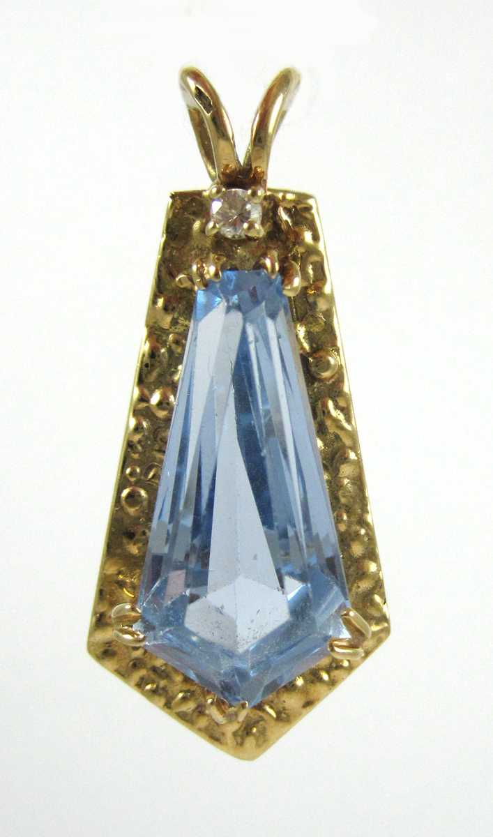 Appraisal: BLUE SPINEL AND FOURTEEN KARAT GOLD PENDANT with a round-cut