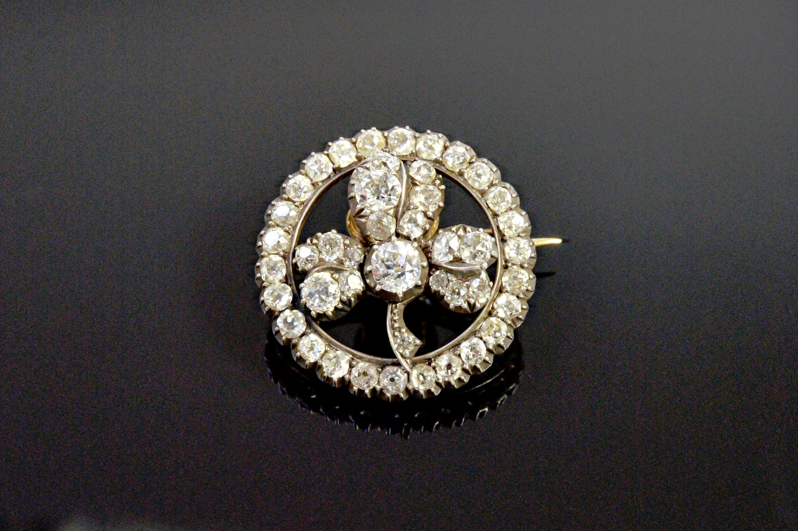 Appraisal: A gold backed and silver set diamond circular brooch the