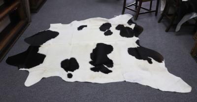 Appraisal: Two black and white hide skin rugs cm x cm