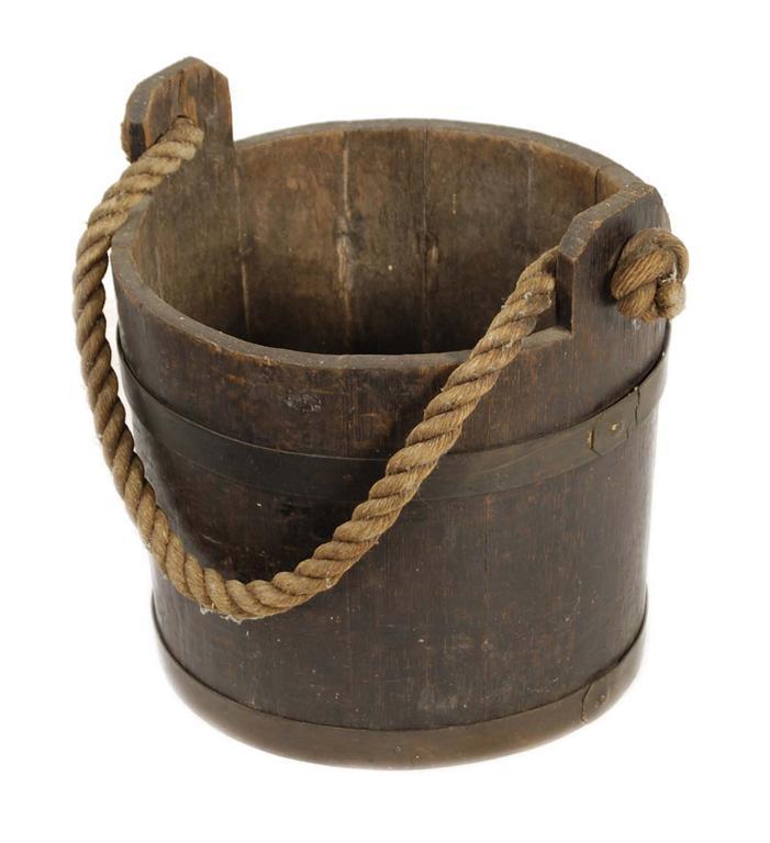 Appraisal: A coopered oak and brass bound bucket