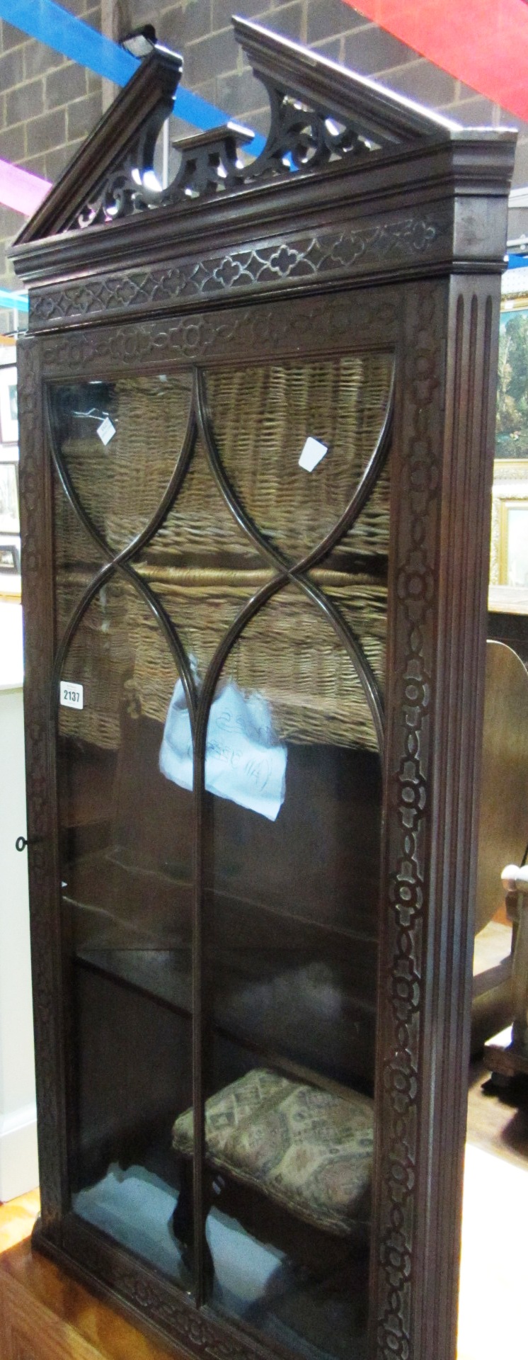 Appraisal: A floor standing mahogany corner cabinet with blind fret decoration