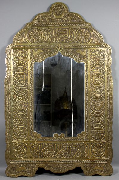 Appraisal: th Century mirror in embossed metal frame ornamented with Arabic