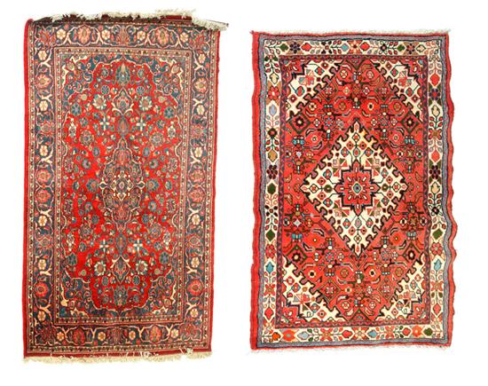 Appraisal: TWO ORIENTAL RUGS Twentieth century Salmon with geometric design and