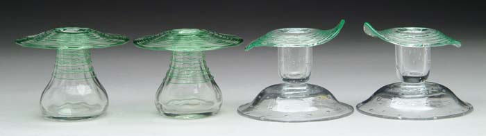 Appraisal: FOUR STEUBEN CANDLESTICKS Pair of clear candlesticks with applied Pomona