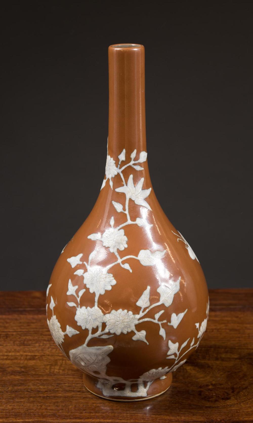 Appraisal: CHINESE PORCELAIN VASE elongated bottle form with white relief floral