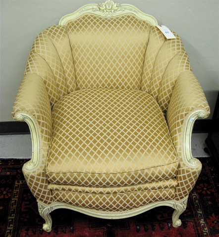 Appraisal: ARMCHAIR AND GLASS-TOP LAMP TABLE gold upholstered easy chair with