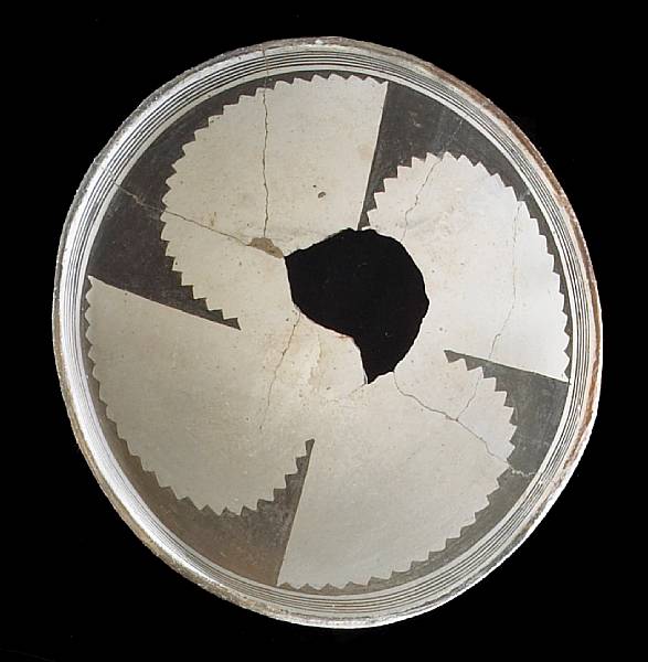 Appraisal: A Mimbres black-on-white bowl Showing a propeller-like negative motif of